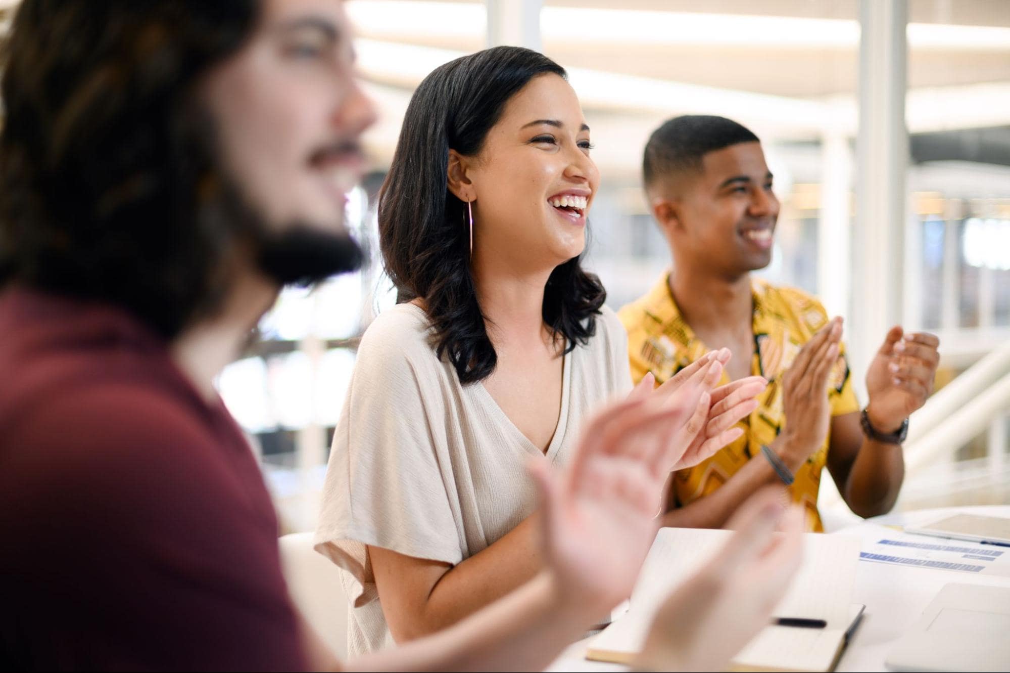 Employees clapping at group meeting for best executive search firm award