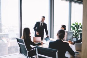 New Hire COO Executive Running Meeting in Upscale Office