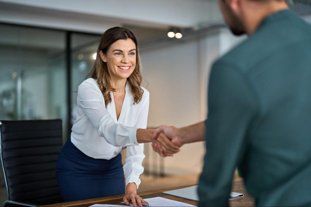 Businesspeople meeting to discuss the benefits of using insurance executive recruiters